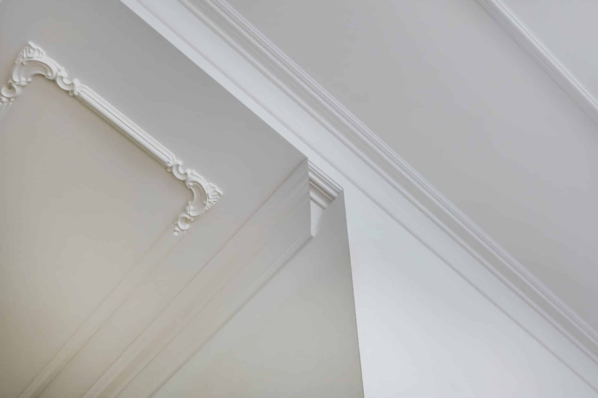 corner of ceiling and walls with intricate crown moulding. Interior construction and renovation concept.