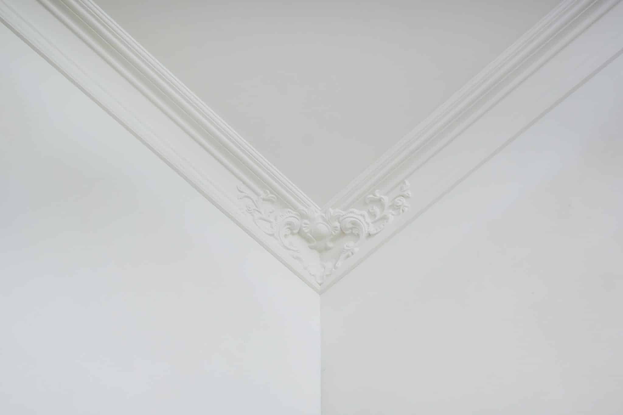 Detail of corner ceiling cornice with intricate crown molding.